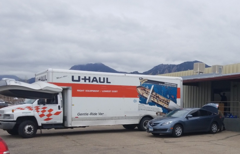 U Haul moving van at Extract Labs in front of mountains.