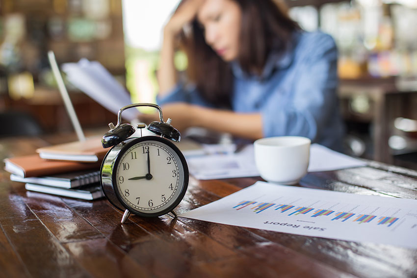 Lady sitting at table stressed image |full spectrum cbd | cbd oil | full spectrum cbd oil | benefits of full spectrum cbd | full spectrum products | how much cbd can I take
