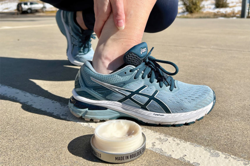someone in running shoes applying our CBD Muscle Cream either before or after a run |full spectrum cbd | cbd oil | full spectrum cbd oil | benefits of full spectrum cbd | full spectrum products | how much cbd can I take