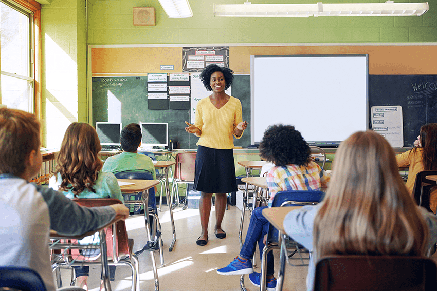 image of a woman teaching in a classroom full of young students for the blog about 5 Effective Ways to Create Back-to-School Bliss