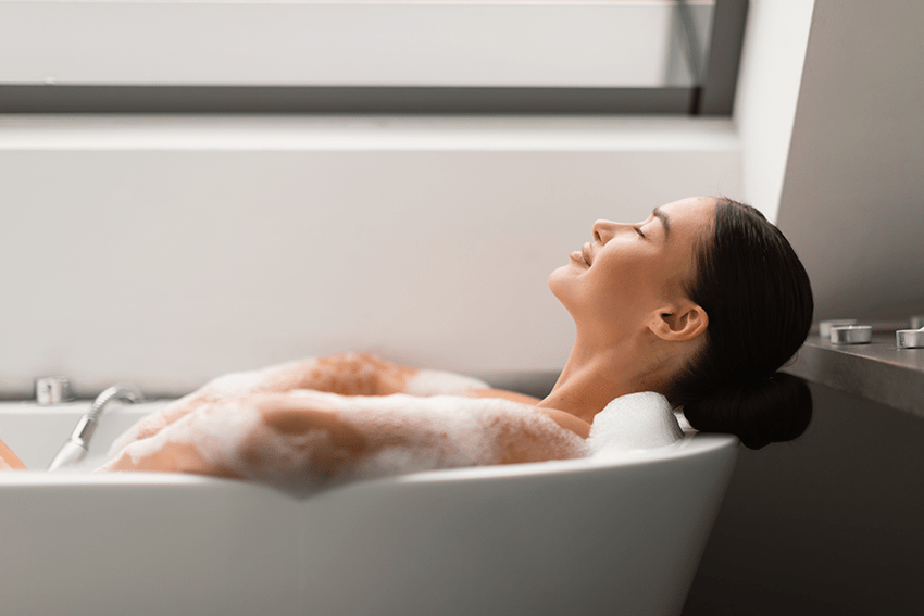 Navigating Your CBD Lifestyle: Selecting the Perfect CBD Products for Your Way of Life 4 image of a woman relaxing in a bubble bath with her eyes closed for the blog about Navigating Your CBD Lifestyle: Selecting the Perfect CBD Product for Your Way of Life