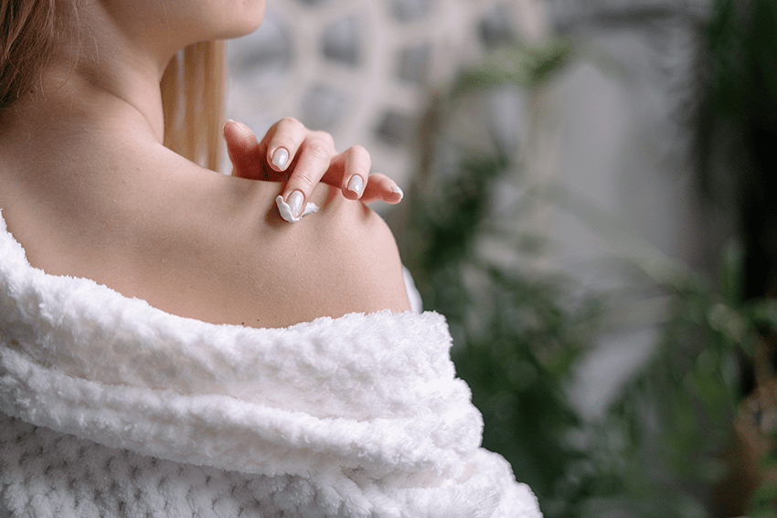 image of a woman applying lotion to her shoulder for the blog about Unveiling Radiance With Our New Hydrate & Nourish Daily Lotion | CBD vs CBG | CBD skincare | CBG skincare | Daily Lotion | CBD Lotion