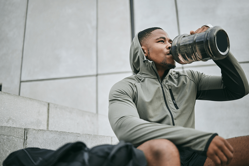 image of a man drinking water around a workout routine for the blog about Workout Recovery Reimagined: Elevate Your Fitness Journey with CBD | cbd and exercise | is it good to take cbd for exercising | cbd for sleep | cbd for pain | cbd for exercise | cbd for pre-workout | cbd for post-workout