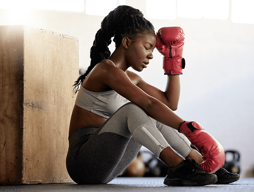 image of a woman resting after working out boxing for blog about Does CBD Potency Matter? A Deep Dive Into the World of CBD Products | CBD Potency | CBD Products | HIgh potency CBD | high potency CBD Gummies | high potency CBD oil