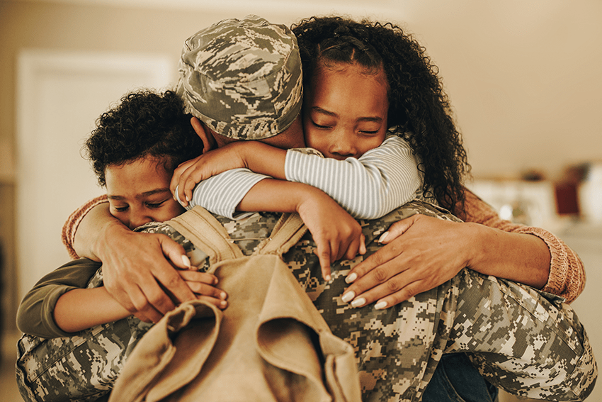 image of kids hugging their military Veteran dad for blog about Honoring Veterans Day: A Tribute to Sacrifice and Service