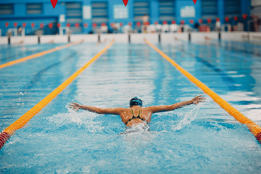 image of swimmer in swimming lane for blog about Elevate Your Game: CBD Products for Athlete Performance | Best workout supplement for men | best recovery supplement | athletic performance