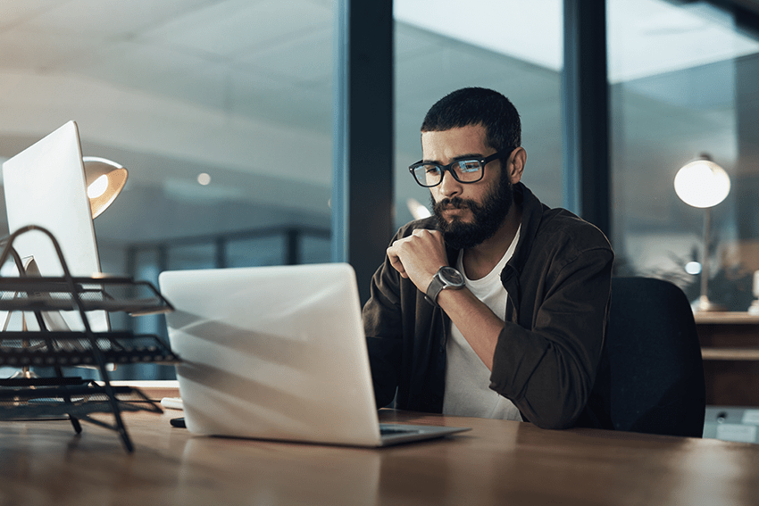 Cannabinoid Guide for Wellness: Discover CBD to Delta 8 1 image of a man focusing in front of a laptop working hard late at night for blog about Cannabinoid Guide for Wellness: Discover CBD to Delta 8