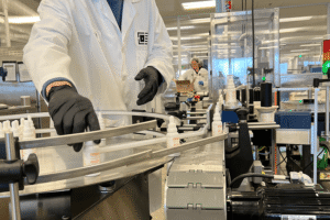 An image of CBD formulations worker performing quality checks on the bottling machine