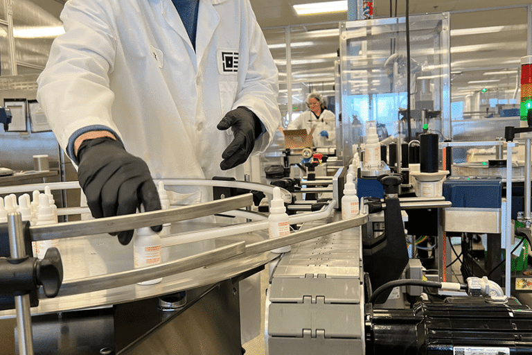 An image of CBD formulations worker performing quality checks on the bottling machine