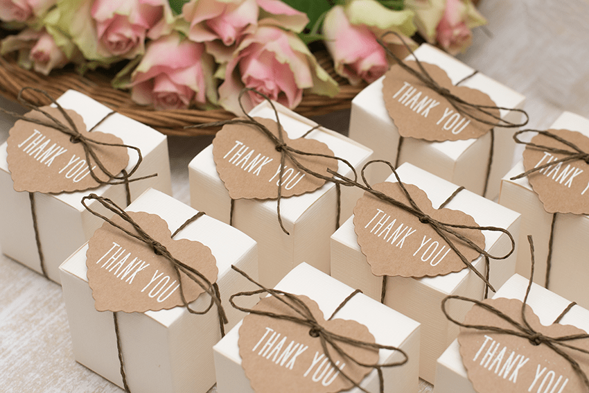 Image of wedding favor boxes on a table for guests. This image is for our blog titled: 3 Elegant and Easy CBD Wedding Favors for Guests