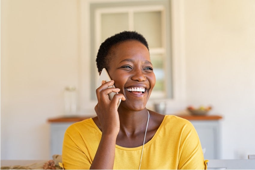 Happy customer on phone with support