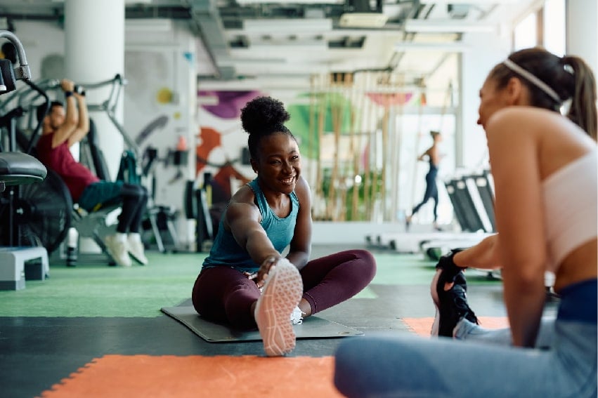 2 women stretching before a workout