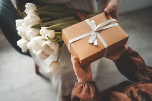 Person handing a thoughtful CBD gift to a friend during a casual moment