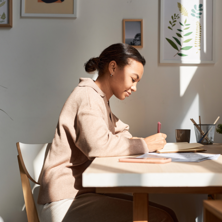 Person sitting at desk in sunlight